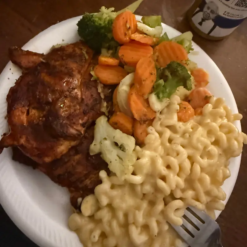 Barbecue chicken with macaroni cheese and buttered mixed vegetables.
